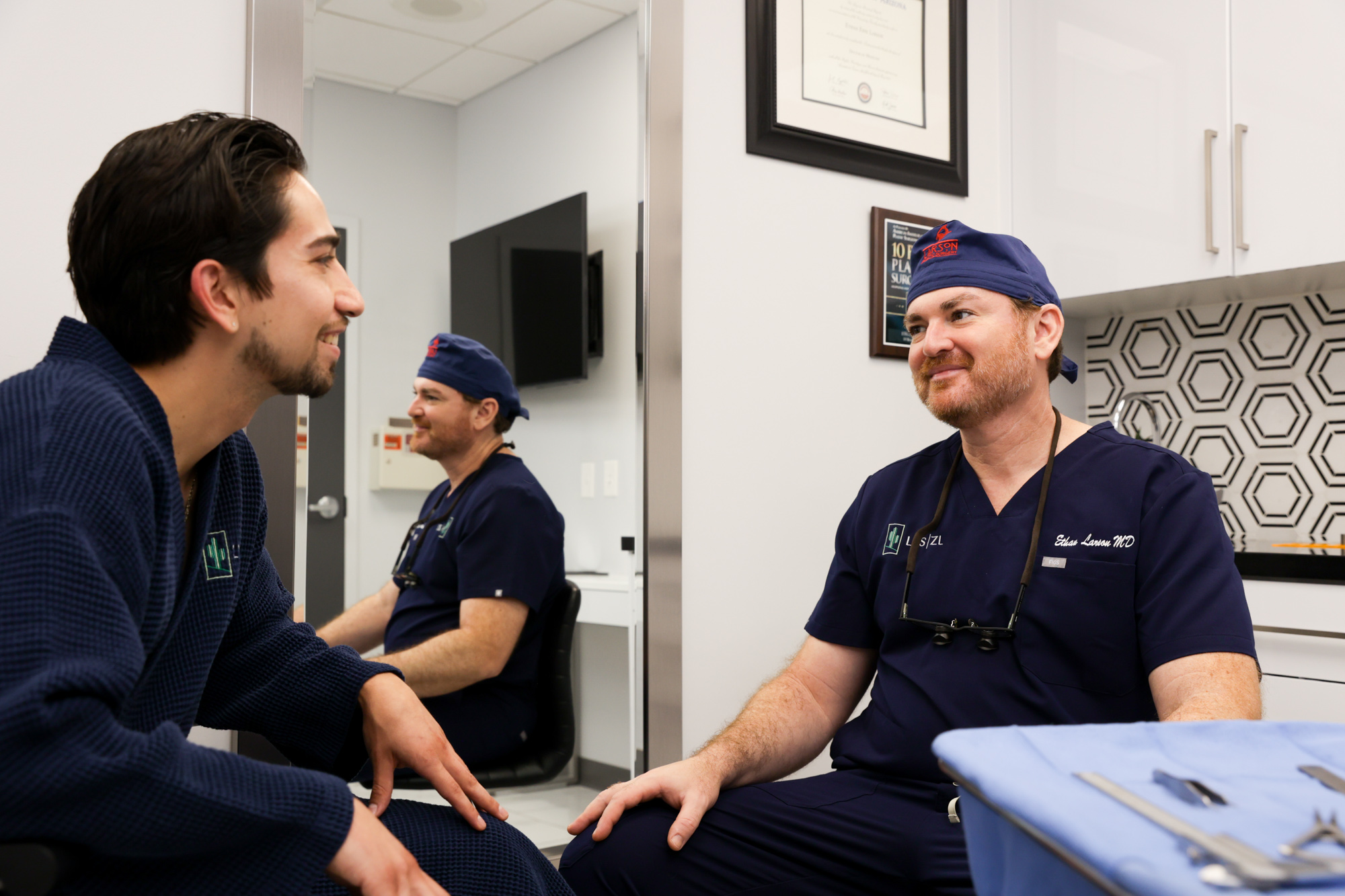 Plastic surgeon sitting with patient discussing gender affirming surgery in Tucson